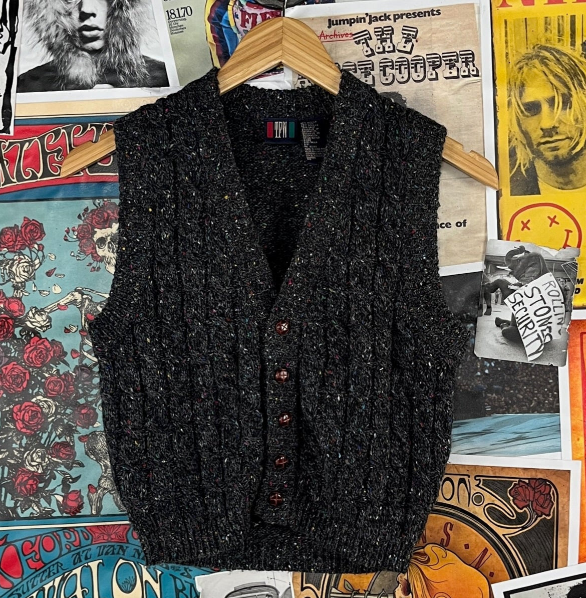 Cool vintage kids 90s dark charcoal grey flecked speckled sleeveless v-neck grandpa style knit sweater vest by TFW. Made of 85% acrylic and 15% wool. Buttons up the front. Is tagged kids size 8, which we estimate to fit ages 7-8. Is technically a boys, but can be worn unisex. It's in great, pre-owned condition. So many ways to style!