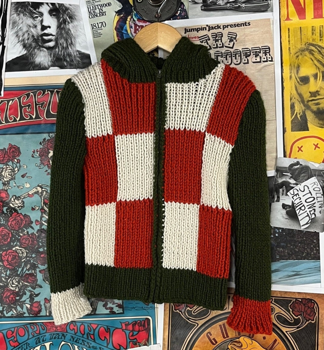 Vintage kids boys girls retro 1960s-70s green, orange, and white check color block print long sleeve knit hooded zip up cardigan sweater. Feels like an acrylic and is in good pre-owned condition. Features a Conmar zipper and appears to be handmade. There is no label or tag size. We estimate it to fit kids size 5, ages 4-5.