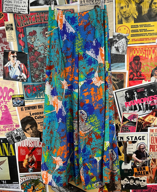A pair of vintage women's high-rise flare trousers with an abstract multicolor print, featuring a Talon zipper at the back. Groovy.