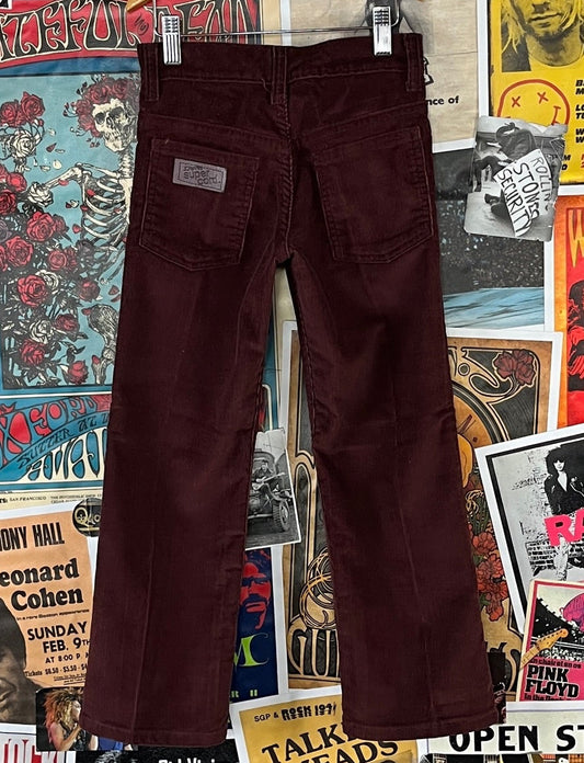 Vintage kids boys girls unisex 1970s-80s burgundy brown bootcut corduroy trouser pants by JCPenney Super Cord. Made of 50% cotton and 50% polyester. Tagged size 8 regular. Please check measurements for accurate sizing. Are in good, pre-owned condition. Features a zip fly and buttons at the waist.
