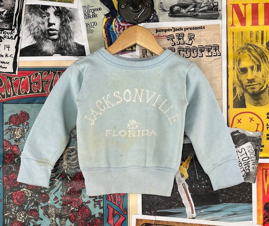 Vintage toddler kids retro unisex boys girls 1950s light pastel blue and white Jacksonville Florida souvenir pullover graphic crewneck sweatshirt. Has staining and wear through out. Perfect grunge rockabilly vibes. There is no label or tag size. We estimate it to fit toddlers size 18-24 months, but please check measurements as this is an estimate.