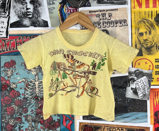 Cool vintage retro boys girls 50s yellow short sleeve single stitch Davy Crockett graphic t-shirt. Is threadbare thin and has some stains through out. Adorable! There is no label or tag size. We estimate it to fit kids size 5, ages 4-5. Please check measurements as this is an estimate.