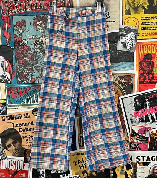 Fun vintage kids girls 70s retro blue multi-color rainbow plaid print elastic waist flares by Teamettes. Tagged size 8. We estimate them to best fit size 8 slim, ages 7-8. Made in the USA of 65% polyester and 35% cotton. Features a decorative attached belt. Has a prior little seam mend on the belt, minor wear on the seat, and a prior mend in the seat. Groovy!