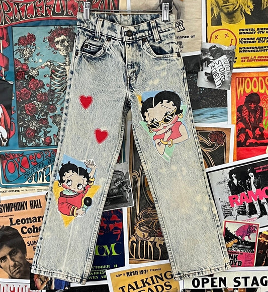 Rad vintage kids girls 1980s acid wash big E orange tab Levi's straight leg custom denim jeans with Betty Boop and hearts patches by So Cute. Made in Los Angeles USA. Are tagged a kids size slim 8. We estimate them to fit girls size 6X-7 slim, but please check measurements. Have light staining through out. Such a unique piece! Features a zip fly.