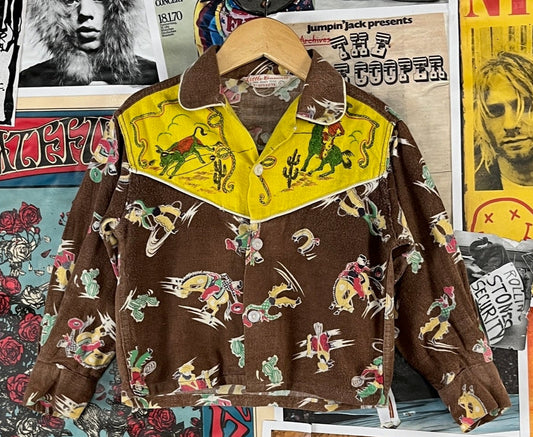 Vintage toddler kids boys 1950s brown, yellow, multi-color Western rodeo rockabilly all over print long sleeve collared sanforized pajama button up shirt by Little Casuals Tiny Town Togs. Is tagged a size 4T.