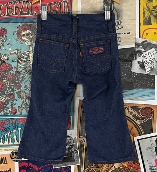 Vintage toddler kids boys girls unisex 1970s-80s blue dark wash denim orange tab Levi's 517 jeans with flare leg. Features a zip fly. Have a reenforced knee patch, but are in otherwise great pre-owned condition. Tagged kids size 3T.